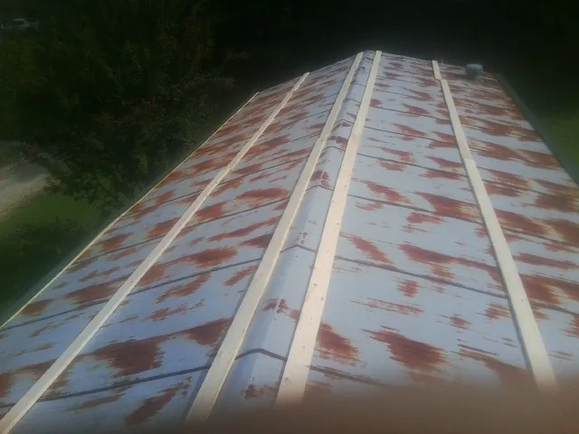 Rusted metal roof panels with new wood purlins before replacement — Storm Damage Roof Repair in Bellflower by Roofing Brothers